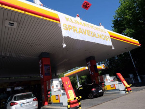 Aktivisté obsadili střechy tří pražských čerpacích stanic. Hasiči jim pomáhali dolů