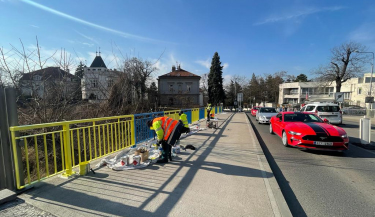 Zábradlí u ruského velvyslanectví v Praze je po opravě v ukrajinských barvách.