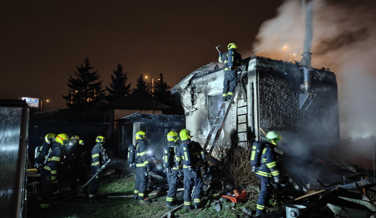 Ve Strašnicích hoří chata. Hasiči předali jednu osobu záchranářům