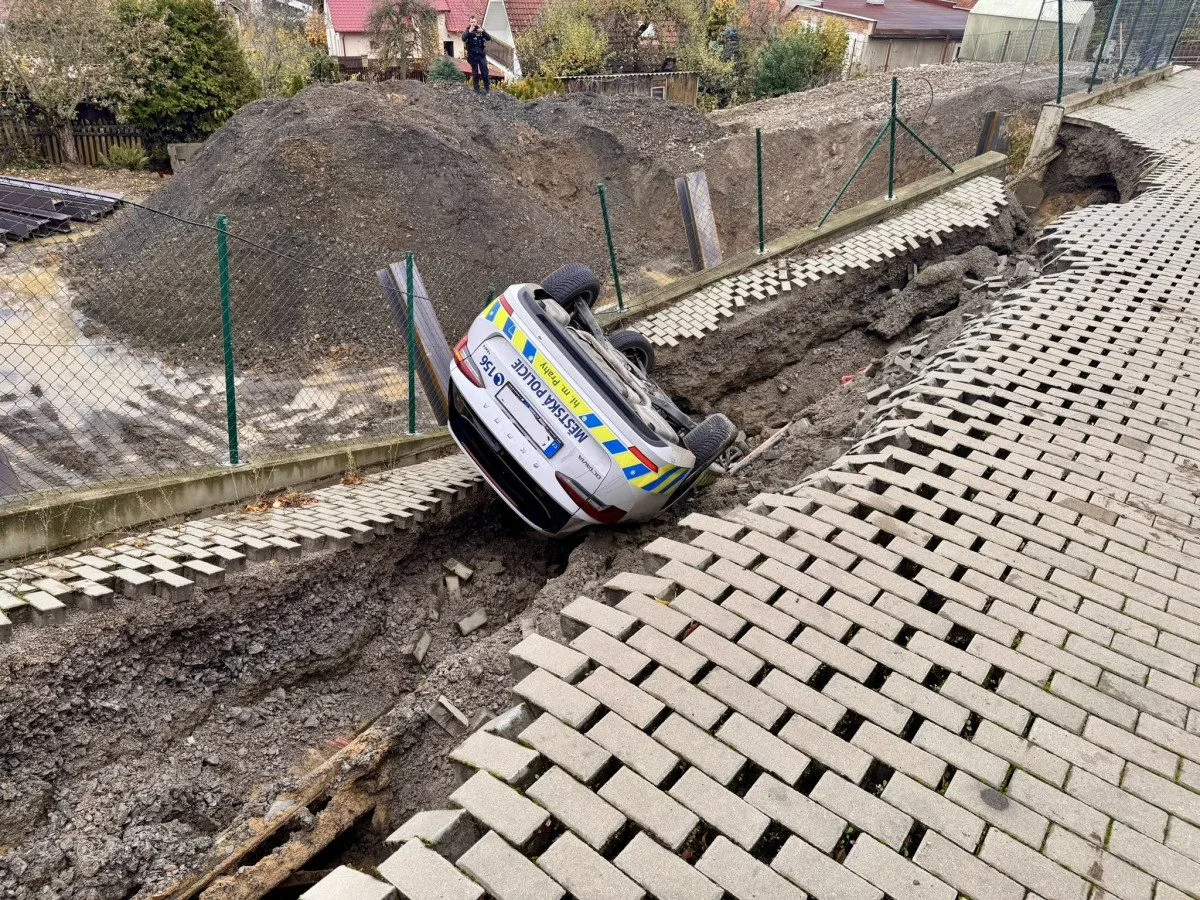 Na stavbě v Praze se utrhl svah, auto městské policie skončilo na střeše