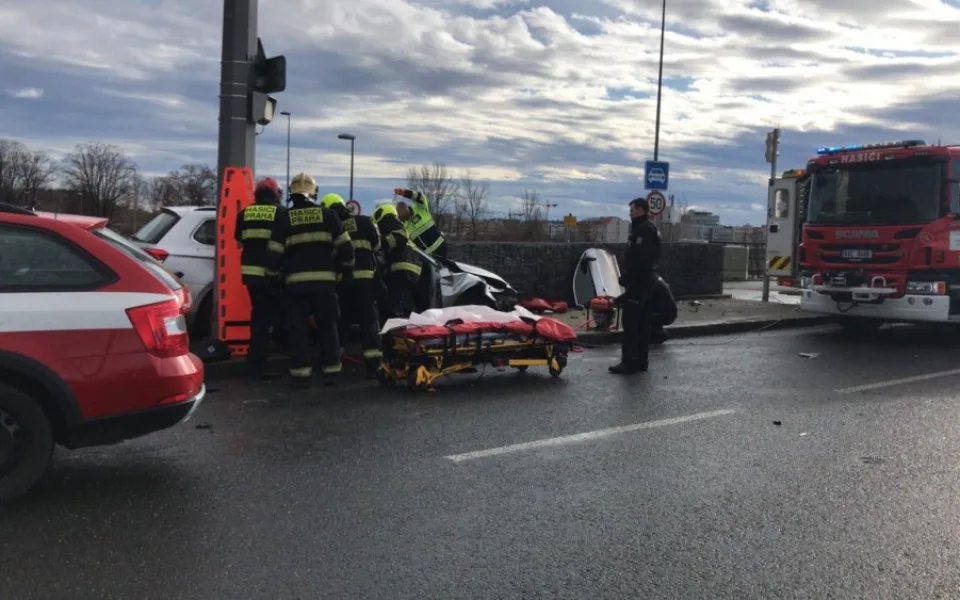 Vážná nehoda na Trojském mostě. Hasiči museli vyprostit dvě osoby z vraku auta.